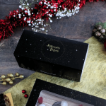 Scatola per ceppo natalizio nera con scritta dorata "Happy Holidays".