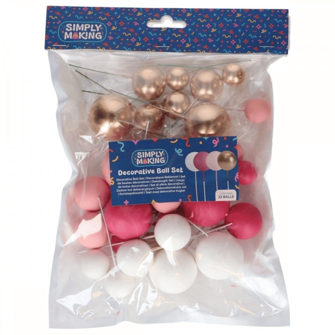 Set di 32 palline decorative per torta nei colori rosa, bianco e oro.